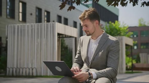 Young Adult Man Works on Laptop, Celebrates