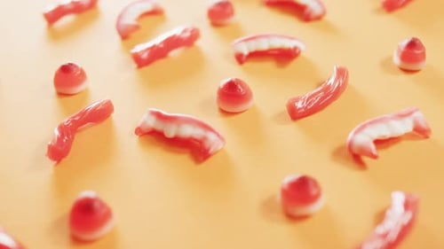 Close up of multiple halloween candies fallen against orange background