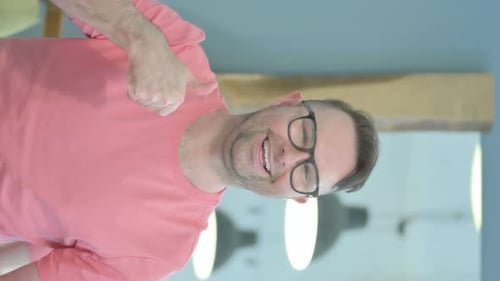 Man Giving Thumbs Up in Vertical Close Up