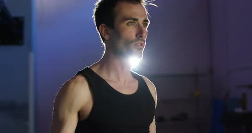young nice man with green eyes doing exercise in the gym. passion for sports concept and healthcar