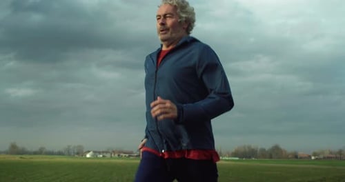 Man Runs on Path in Rural Field
