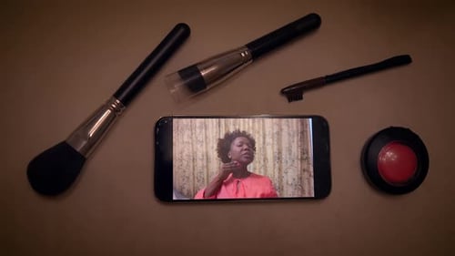 Woman Giving Make Up Tutorials on Mobile Screen