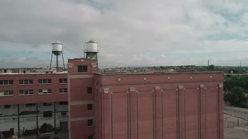Drone view of the side of a red industrial building in Denver