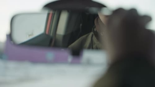 Rearview Mirror Close Up Reflecting Boy Adjusting Mirror with Soft Winter Light