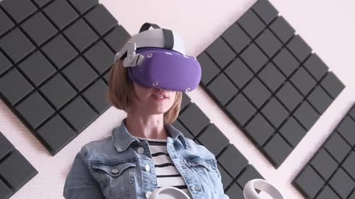 Woman Uses Virtual Reality Headset with Controllers