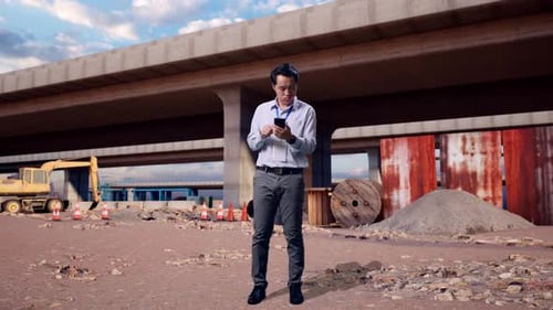 Asian Male Dissapionted While Use Phone At Building Site