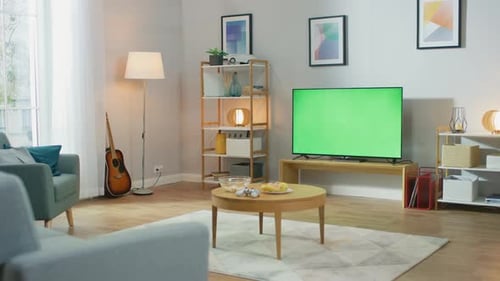 Cozy Living Room with Stylish Furniture and Design, Green Chroma Key TV in the Middle of the Room.