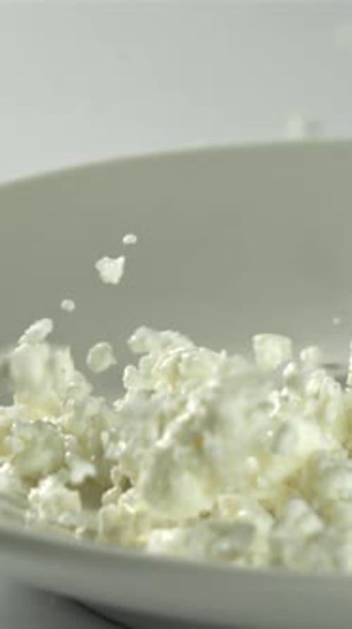 Fresh Cottage Cheese Falls Into the Plate Filmed on a Highspeed Camera at 1000 Fps