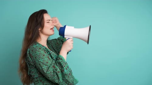 Young Woman Protesting with Megaphone in Blue Studio