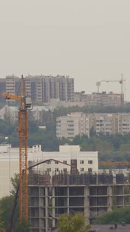 Construction Site with Workers Crane and Unfinished Building