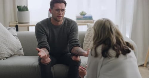 Man Talking With Therapist on Couch Indoors