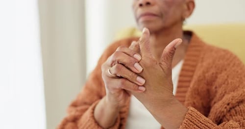 Hands, pain and arthritis with an elderly woman in her nursing home, struggling with a medical
