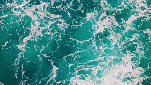 Top Down Aerial View of Beautiful Giant Blue Ocean Waves Crashing and Foaming with White Wash