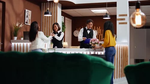 Hotel Reception Desk with Staff and Guests