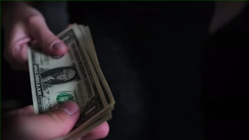 Close Up of Hands Counting Money