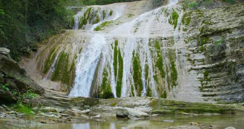 A wonderful, beautiful place with a rocky slope and a waterfall, the source of te sound of gentle