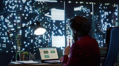 Man Working at Desk Late at Night