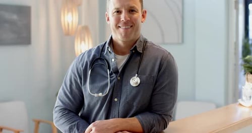 Smiling doctor with stethoscope in modern medical office, ready to assist patients