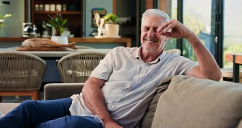 Senior man, face and break in lounge, laugh and comfortable on couch with smile or chilling in home