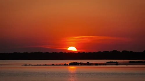 Awesome Sunset Over the Water in Orange Sky with Soft Clouds Timelapse