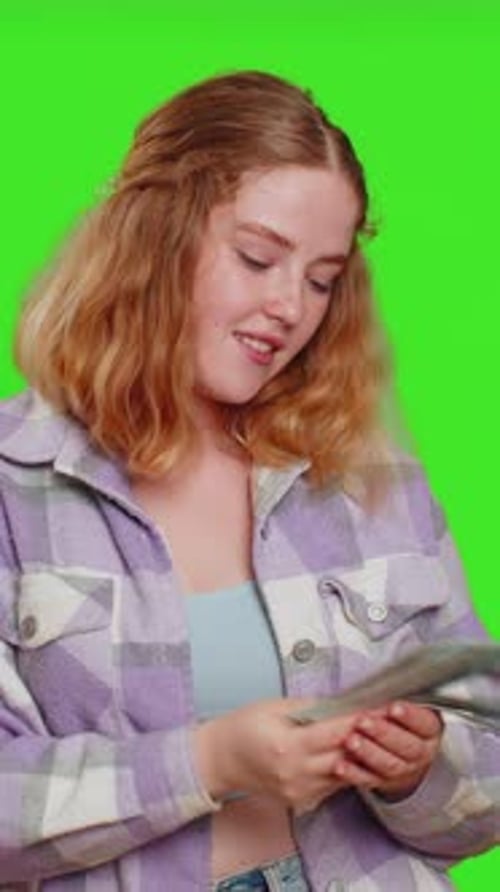 Smiling Woman Holding Money on Green Screen Background