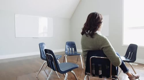 Woman Waiting for Support Group Meeting to Start in Community Center 10 Seconds or Greater