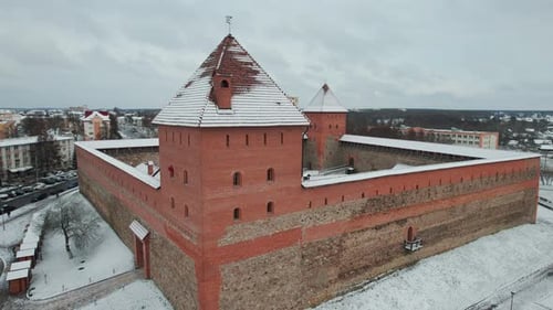 Shooting From Drone of Medieval Fortress with Red Brick Towers with Weather Vanes on the Roofs in