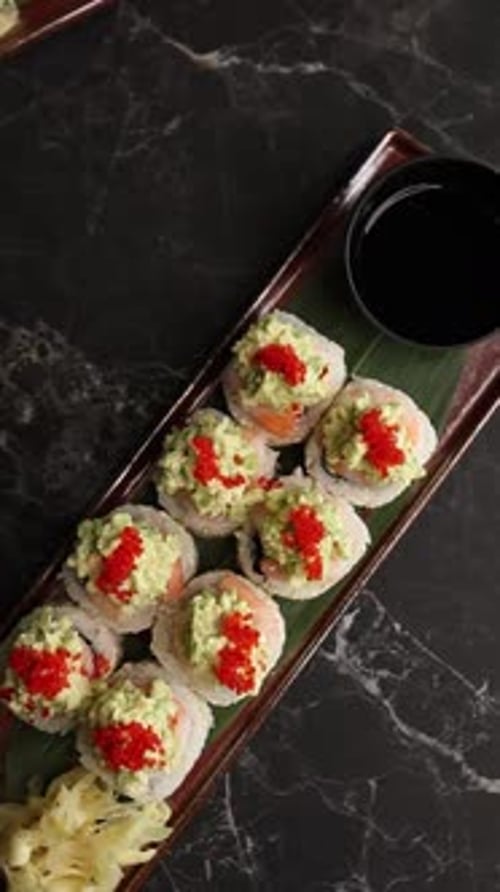 Close-up of delicious Japanese sushi rolls served fresh on a plate in a restaurant.