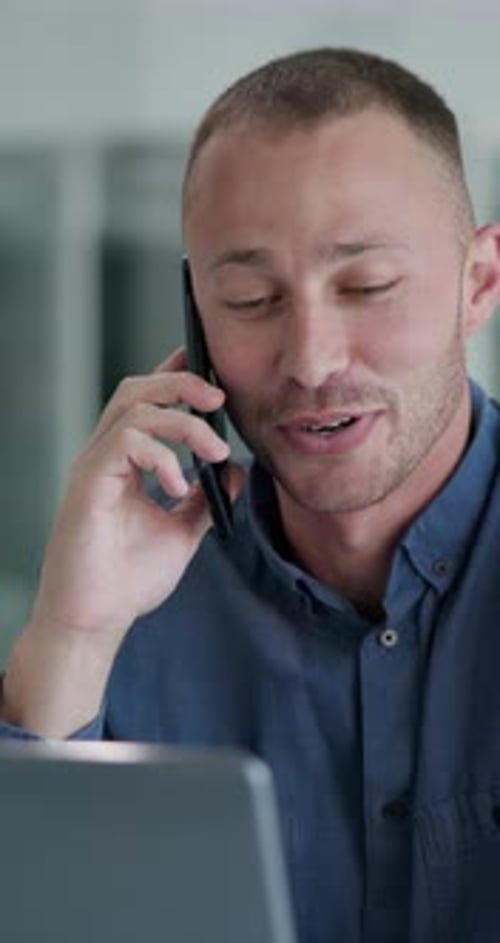 Young Adult Man Talking on Phone Holding Tablet