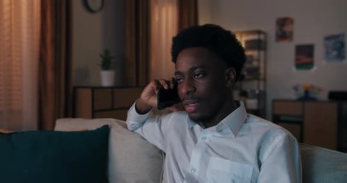 Young Man Talking on Phone at Home