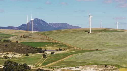 Drone, wind turbine and renewable energy on landscape on field, sky or clouds for eco friendly
