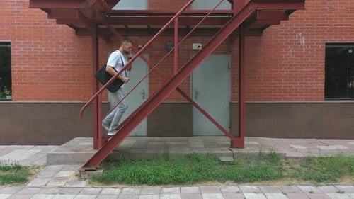 Businessman Climbing Up the Stairs of a Business Centre