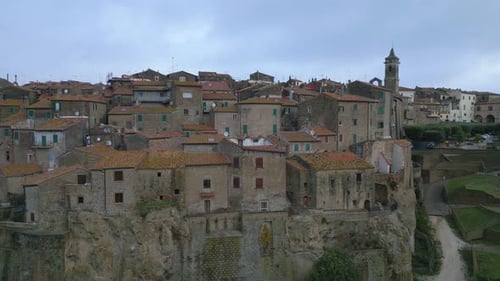 Aerial view of an Italian medieval town at first light on an autumn day, medium shot, long shot