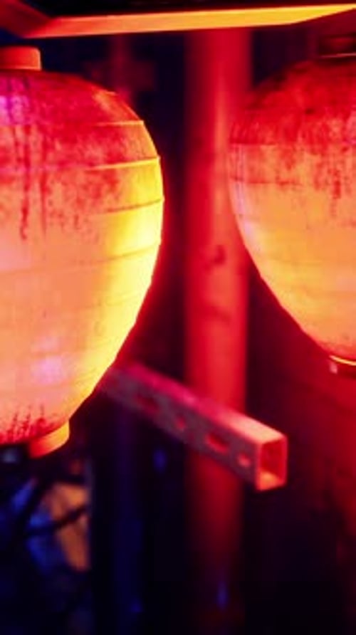 Three Red and Yellow Lanterns Hanging From a Pole