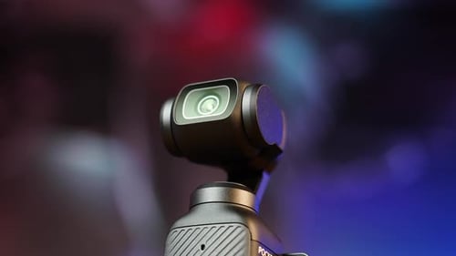 Close up of small pocket size electronic camera with gimbal stabilization