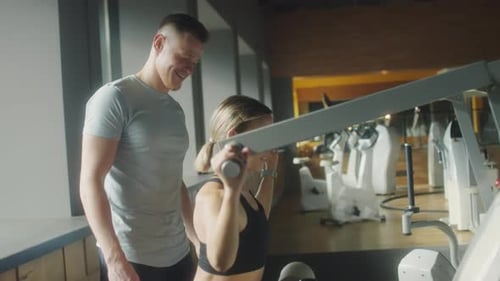 Woman Training in Gym with Fitness Instructor