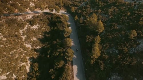 Aerial view of truck with cargo is driving on a white rural road. Drone footage.
