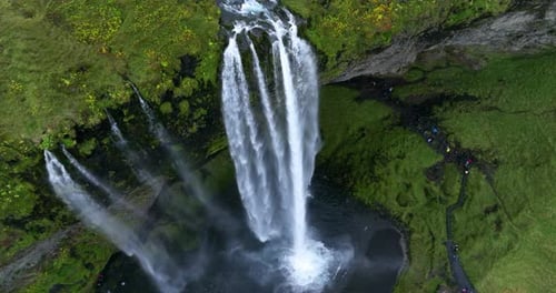 Seljalandsfoss Waterfall Cascading From A Sheer Cliff In Southern Iceland. - aerial shot