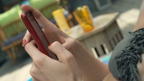 Woman Texting on Smartphone Lying Sunbed in Outdoor Bar Adult