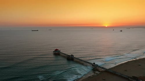 Sun setting above the waterscape of the Pacific Ocean.