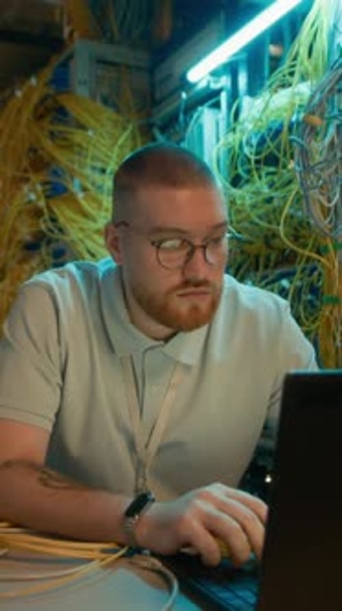 Man and Woman Discussing Cables in a Server Room