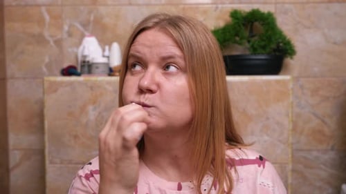 Woman Brushing Teeth in Bathroom Close-Up