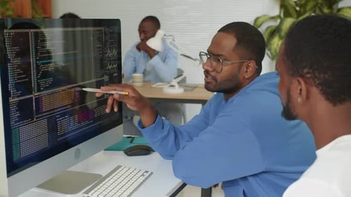 Two Programmers Fixing Bags in Script while Coding at Office