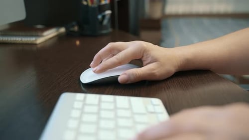 Hands Typing and Using Mouse on Desktop