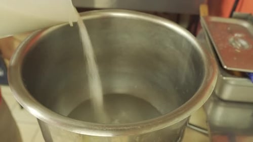 Sugar Being Poured into Large Mixing Bowl