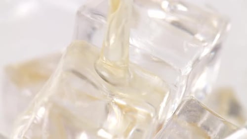 Close Up Of Being Poured Over Ice Cubes