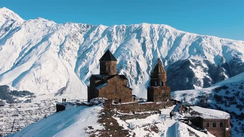 Old Christian Monastery Hidden Among Snow Capped Mountains
