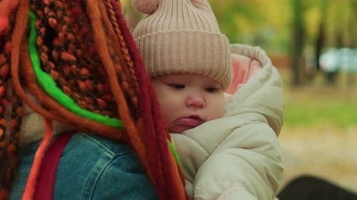 Baby in the Arms of His Mother in the Autumn Park Soft Focus