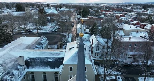 Weather vane atop church steeple in small town America. Lititz Pennsylvania USA establishing aerial