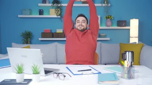 Man working from home office showing how to exercise in office.